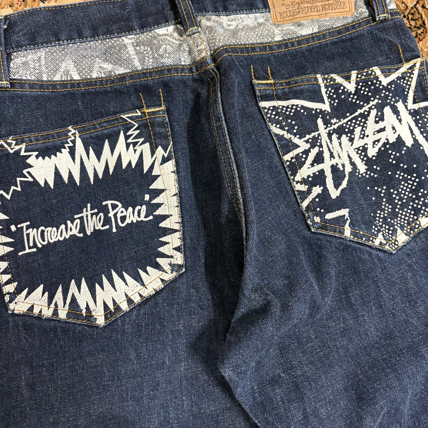 Stussy navy blue graphic jeans (W30”)